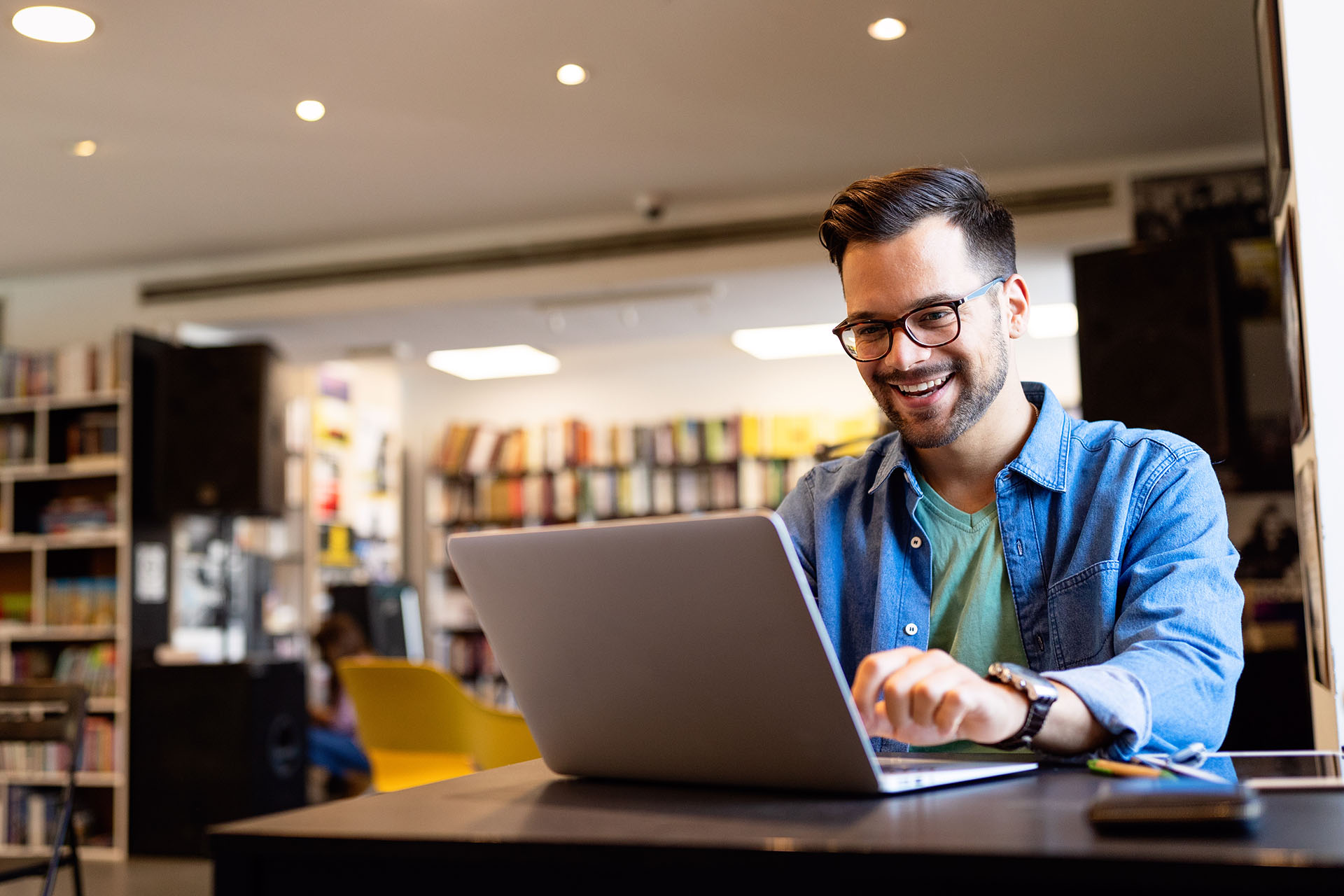 Happy young man working on laptop. Technology people work study concept